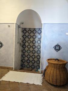 a bathroom with a shower and a vase next to a wall at The Place Yoga Retreat *FREE YOGA CLASS in Pantelleria