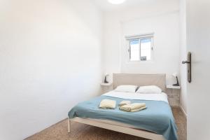 a bedroom with a bed with two towels on it at BLife Marya private rooms in Faro
