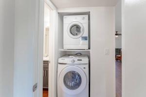 a laundry room with a washing machine and a washer at Cactus Rd 2 BR Condo with Pool View Balcony in Phoenix