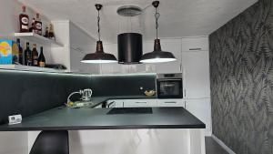 a kitchen with two pendant lights and a counter top at Pure Homolje in Krepoljin