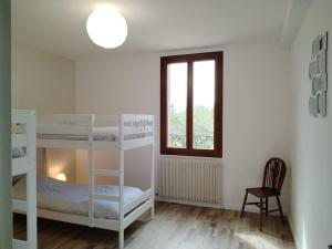 a bedroom with two bunk beds and a window at Au gîte Sérénité in Mouthier-en-Bresse