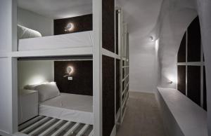 a small room with two bunk beds in it at Hostel 16 Oia in Oia