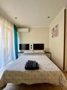 a bedroom with a bed with a blanket on it at Spanish style flat close to center in Alicante