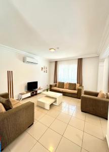 a large living room with couches and a tv at Anfora Villaları in Belek