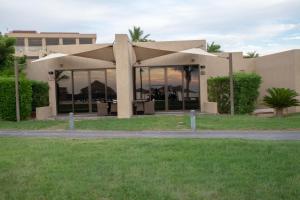 a building with a lot of windows in front of it at Royal L'azure Resort in Sharmaa