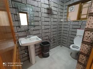 a bathroom with a sink and a toilet at Valley holidays in Srinagar