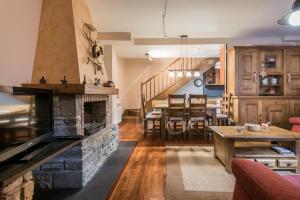 a living room with a fireplace and a dining room at Casa Garona by SeaMount Rentals in Bossost