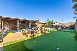 a yard of a house with a putting green at Scottsdale - 15035 N 54th St in Phoenix