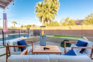a patio with a table and chairs and a pool at Scottsdale - 15035 N 54th St in Phoenix
