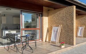 a patio with a table and chairs on a balcony at Bornholm Apartments in Svaneke