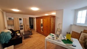 a living room with a white table and a couch at Rathenaustraße in Berlin