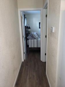 a hallway leading to a bedroom with a bed at City Scape Homey 1 BR efficiency Apt near TTU and downtown in Cookeville