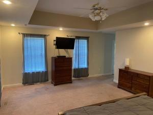 a bedroom with a bed and a flat screen tv at Home just outside of Hendersonville in Hendersonville