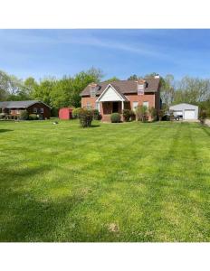 a house with a large yard with green grass at Home just outside of Hendersonville in Hendersonville