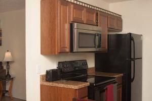 a kitchen with a black refrigerator and a microwave at Can't get closer to Fort Sill then this! in Lawton