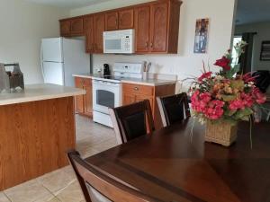 a kitchen with a table with a vase of flowers on it at Spacious 3BR 2BA 11 mins away from Cummins Falls State Park!!! in Cookeville