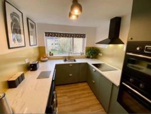 a kitchen with a sink and a counter top at K Suites - Park Grange Croft in Sheffield