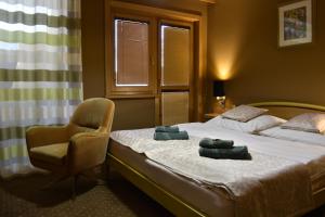 A bed or beds in a room at Penzion Jople