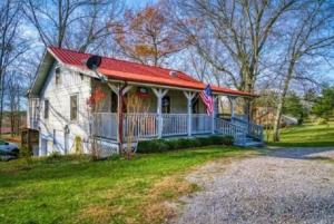 een klein wit huis met een rood dak bij Pigeon Ridge Cabin Cumberland State Park 2B 2B in Crossville