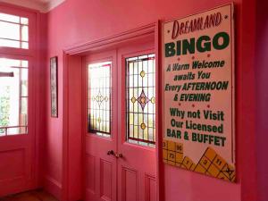 a red room with a sign on the wall at Beautiful Beachfront Townhouse in St. Leonards