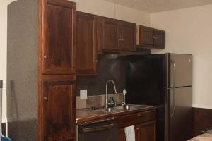 a kitchen with a sink and a refrigerator at Less than 1 mile from Fort Sill 2 Bedrooms!!!! in Lawton