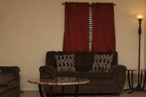 a living room with a couch and a table at Less than 1 mile from Fort Sill 2 bedrooms! in Lawton
