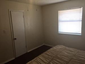 an empty bedroom with a bed and a window at One bedroom close to Fort Sill! in Lawton