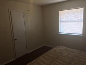 an empty bedroom with a bed and a window at One bedroom close to Fort Sill! in Lawton