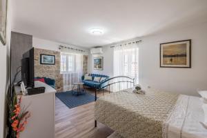 a bedroom with a bed and a living room at Holiday Home Riva Promenade in Split