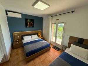 a bedroom with two beds and a window at DOMAINE MAXXIM in Clermont-lʼHérault