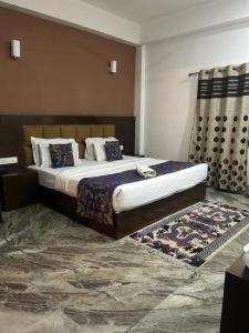 a bedroom with a large bed and a rug at Twin Spring in Gangtok