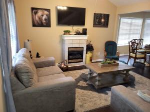 a living room with a couch and a fireplace at Cozy Pigeon Forge home w hot tub near river in Pigeon Forge