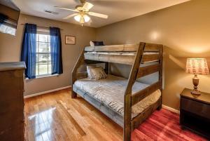 a bedroom with two bunk beds and a ceiling fan at Entire house close to everything in Sevier County in Pigeon Forge