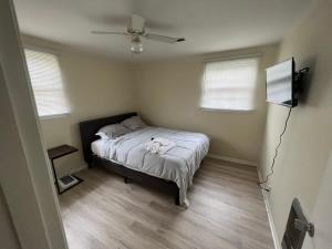 a bedroom with a bed and a ceiling fan at A great place for you to come rest your head in Gallatin