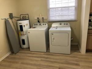 a kitchen with two washing machines and a washer and dryer at A great place for you to come rest your head in Gallatin