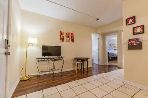 a living room with a table and a flat screen tv at Check it out! 2 BR/ 1 B Apt very close to 1-24 in Chattanooga