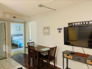 a dining room with a table and a tv and a bedroom at 2 Bed/ 1 Bath efficiency Apartment- Close to Downtown! in Chattanooga