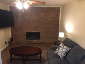 a living room with a couch and a fireplace at Be comfortable in a house close to base in Lawton