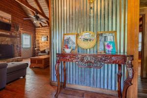 a living room with a table with pictures on it at Genuine log cabin minutes away from Chattanooga's top attractions in Chattanooga