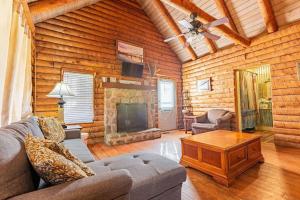a living room with a couch and a fireplace at Genuine log cabin minutes away from Chattanooga's top attractions in Chattanooga