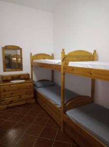 two bunk beds in a room with a mirror at Casa Portopaglia in Gonnesa