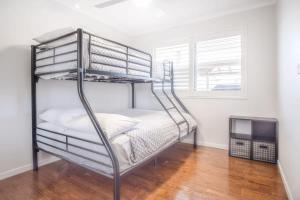 a couple of bunk beds in a room at Pet Friendly family Home with Pool - Walk to Warana beach in Buddina
