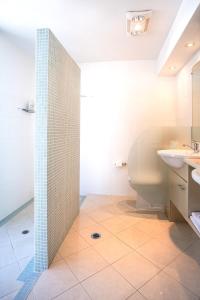 a bathroom with a toilet and a sink at Live like a local In The Heart of Moffat Beach in Caloundra