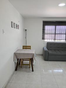 a living room with a table and a couch at Cozzy studio inside walled city & historic center in Cartagena de Indias