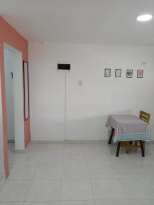 a white room with a table and a chair at Cozzy studio inside walled city & historic center in Cartagena de Indias
