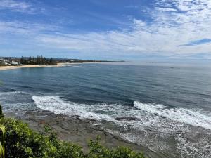a view of a beach with the ocean at Moffat Beach Coastal Contemporary Unit B in Caloundra