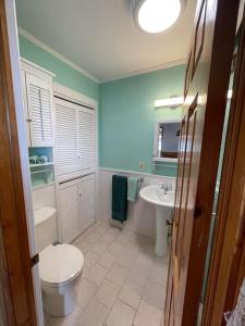 a bathroom with a toilet and a sink at Ardan Cottage in Ingonish in Ingonish Beach