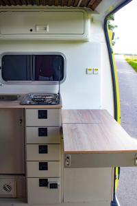 a kitchen in an rv with a table in it at Camper On Road Tenerife in Los Cristianos
