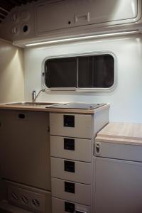 a kitchen with a sink in an rv at Camper On Road Tenerife in Los Cristianos