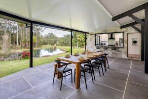 a dining room with a table and chairs at The Noosa Ranch- Where Nature meets Luxury in Tinbeerwah